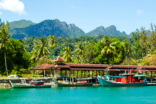 Langkawi, officially known as Langkawi, the Jewel of Kedah, is a district and an archipelago of 99 islands in the Andaman Sea some 30 km off the mainland coast of northwestern Malaysia. The islands are a part of the state of Kedah, which is adjacent to the Thai border.